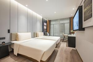a hotel room with two beds and a desk at Atour Hotel Chengdu Taikoo Li Chunxi Road Pedestrian in Chengdu +74 photos