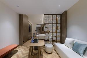 a living room with a white couch and a table at Atour S Hotel Beijing Zhongguancun Beiwai in Beijing