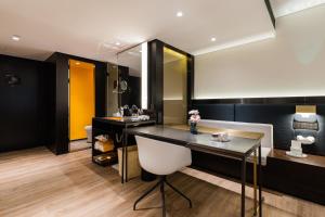 a bathroom with a sink and a desk with a mirror at Atour S Hotel Shanghai Lujiazui Financial Center in Shanghai
