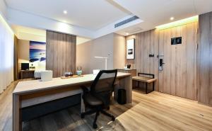 an office with a desk and a chair at Atour Hotel Dalian Development Zone Jinma Road in Dalian