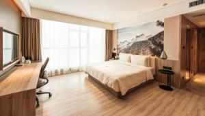 Habitación de hotel con cama y escritorio en Atour Hotel North High Speed Railway Station Xi'an, en Xi'an