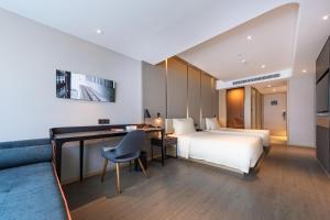 a hotel room with a bed and a desk at Atour Hotel Shenzhen Baoan International Convention and Exhibition Center in Bao'an