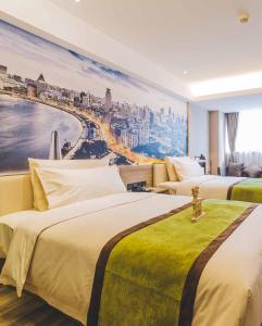 a hotel room with three beds and a painting on the wall at Atour Hotel Shanghai Lujiazui Babaihan in Shanghai