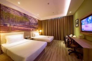 a hotel room with two beds and a flat screen tv at Atour Hotel Jinan High-tech Wanda Plaza Tiancheng Road in Jinan +46 photos