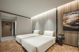 Postel nebo postele na pokoji v ubytování Atour Hotel Shanghai Center Lujiazui + 27 fotografií
