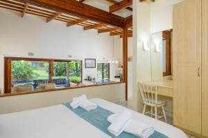 a bedroom with a bed and a desk and a table at San Lameer Villa 2026 - 1 Bedroom Classic - 2 pax - San Lameer Rental Agency in Southbroom +25 photos
