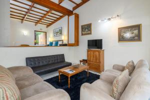 a living room with two couches and a tv at San Lameer Villa 2026 - 1 Bedroom Classic - 2 pax - San Lameer Rental Agency in Southbroom