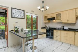 a kitchen with a table and a counter top at San Lameer Villa 2026 - One bedroom Classic - 2 pax - San Lameer Rental Agency in Southbroom