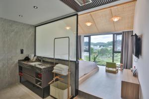 a bathroom with a sink and a large mirror at Heaven's Gate Home Stay in Zhangjiajie