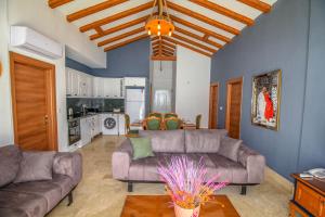 a living room with two couches and a kitchen at Patara Tiffany 3+1 Villa, Özel Havuzlu, Fethiye in Fethiye