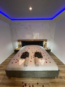 a bedroom with a bed with two pairs of shoes at Luxury spa vallon in Vallon-Pont-dʼArc