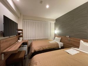 Postel nebo postele na pokoji v ubytování Kusatsu Daiichi Hotel + 32 fotografií