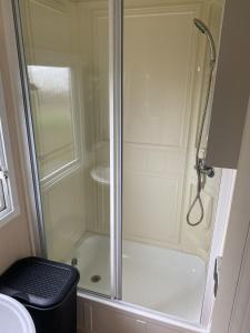 a shower with a glass door in a bathroom at NV 1153 - Beach Resort Nieuwvliet Bad in Nieuwvliet