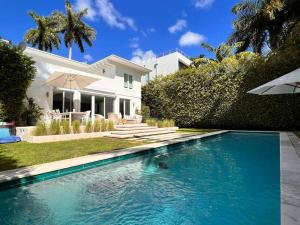 a swimming pool in front of a house at Villa Naomi - Luxury Design New Home in Miami