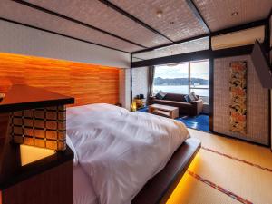 A bed or beds in a room at Kurofune Hotel