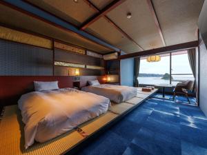 A bed or beds in a room at Kurofune Hotel