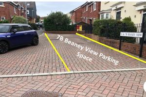 a car parked in a parking lot with a new parking space at Beaney View House - Comfortable Spacious 4 Bedrooms En-suites House with Free Wifi and Parkings Located at quiet neighbourhood and easy access to town centre in Swindon