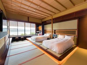 A bed or beds in a room at Kurofune Hotel