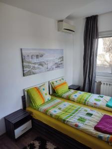 1 dormitorio con 2 camas y ventana en Villa Strashimirovo, en Strashimirovo