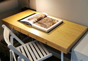 a wooden table with a book on top of it at LuxOry Center - Brescia centro in Brescia