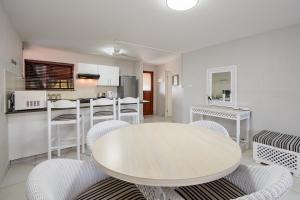 a kitchen and dining room with a table and chairs at San Lameer Villa 2510 - 1 Bedroom Classic - 2 pax - San Lameer Rental Agency in Southbroom