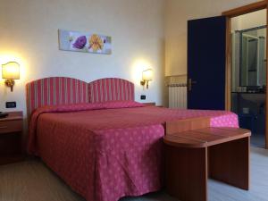 Postel nebo postele na pokoji v ubytování Coccodrillo Hotel & Apartments