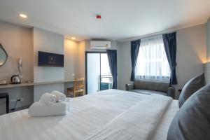 Postel nebo postele na pokoji v ubytování Cozy Blu Suvarnabhumi