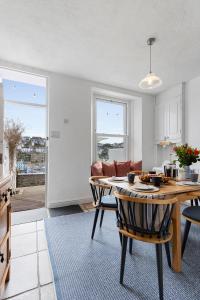 a kitchen and living room with a table and chairs at Polly's Place, Brixham in Brixham