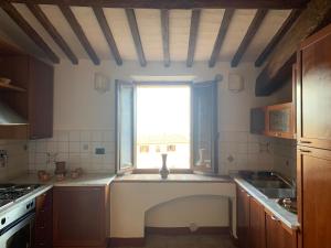 a kitchen with a window in the middle of it at L'Attico dei Sogni in San Gimignano +44 photos