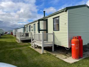 a row of mobile homes and a fire hydrant at R&S HOLIDAY HOMES THE CHASE r14 in Skegness