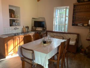 a kitchen with a table with chairs and a sink at Villa Katina in Arethousa