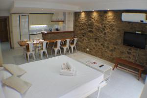 a living room with a table and chairs and a tv at Agi Pi Sunyer Apartments in Roses