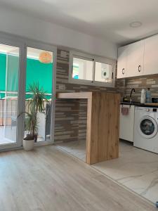 a kitchen with white cabinets and a plant in a room at Sunny 3 bed beach flat - large terrace with sea view in Puerto de Sagunto