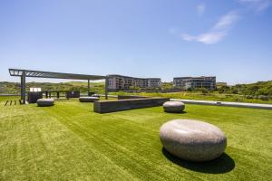 a garden with large rocks on the grass at Modern Garden Unit in Pebble Beach in Umhlanga