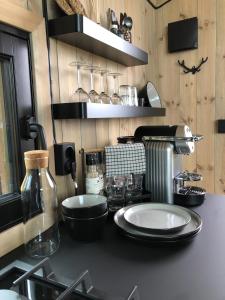 a kitchen with a counter with plates on it at Baugsberget Fjelltopphytter in Alvdal