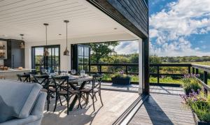 a patio with a table and chairs on a deck at Retallack Resort & Spa in Padstow