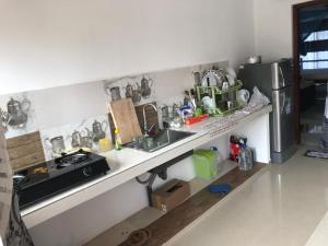 een keuken met een wastafel en een koelkast bij Hotel Meer in Ambalangoda