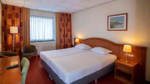 Postel nebo postele na pokoji v ubytování Parkhotel Valkenburg