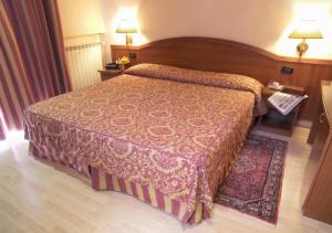 Postel nebo postele na pokoji v ubytování Coccodrillo Hotel & Apartments