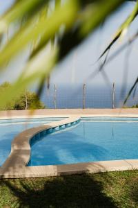 a swimming pool with blue water in a yard at Casa Tramuntana in Valldemossa