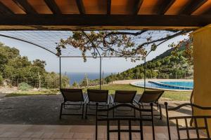 a patio with chairs and a table and a pool at Casa Tramuntana in Valldemossa