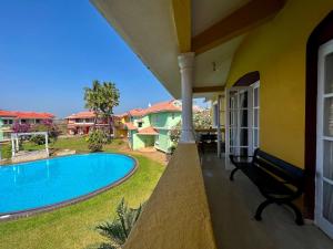 a view from the balcony of a house with a swimming pool at Villa Marina By The Beach Goa in Benaulim