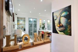 a art exhibit with a painting of a woman at Luxury villa with a heated pool, Jakuzi and a sea view 70m from the beach in Herzliya