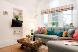 a living room with a couch and a table at West Lodge - Seasgair Lodges in Kincraig