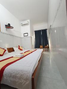 Postel nebo postele na pokoji v ubytování Motel Toàn Thắng