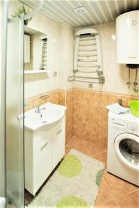 a bathroom with a sink and a washing machine at Apartments Marina in Rafailovici