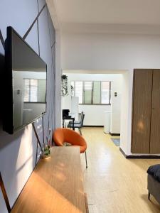 a living room with a television on a wall at Bat Galim - Mirror Apartment by the beach in Haifa