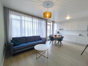 a living room with a blue couch and a table at K50171 Modern apartment near the center and free parking in Eindhoven