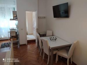 a dining room with a table and chairs and a television at AL171 Tourist Rental close Metro B1 - Sant'Agnese Annibaliano in Rome