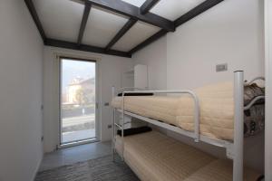 ein Krankenhauszimmer mit einem Etagenbett und einem Fenster in der Unterkunft Casa Silù - Lago di Como in Colico